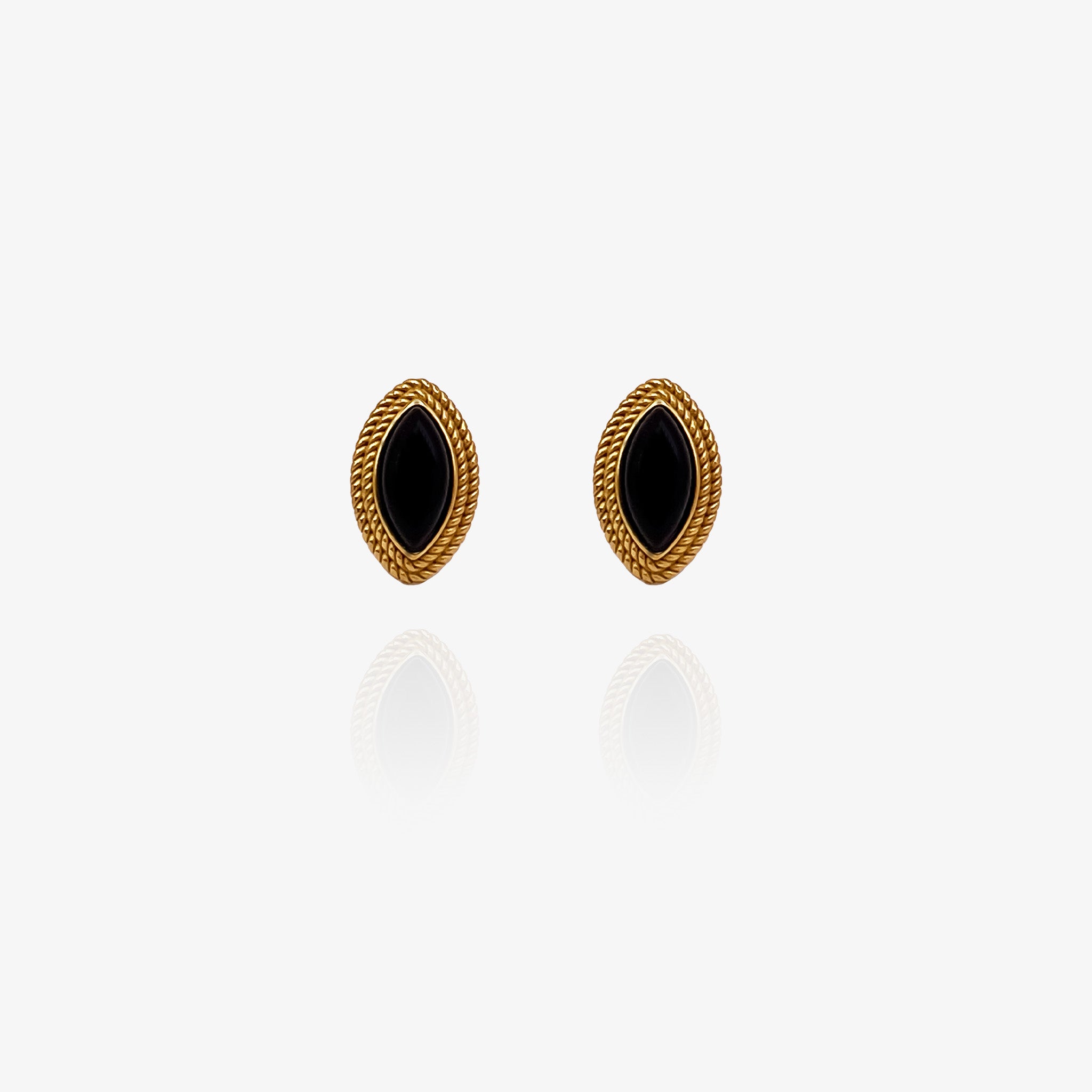 Pair of gold earrings with black stones on a white background